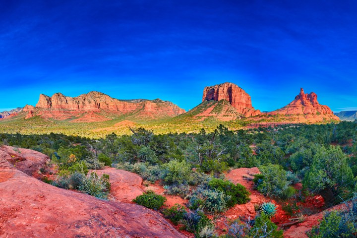 Panoramic view of Sedona's red rock formations under a clear blue sky.